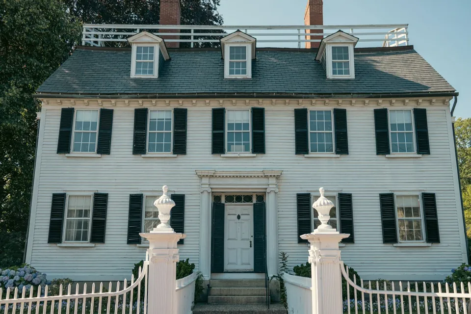 Freshly painted clapboard colonial with black shutters and white trim in Massachusetts