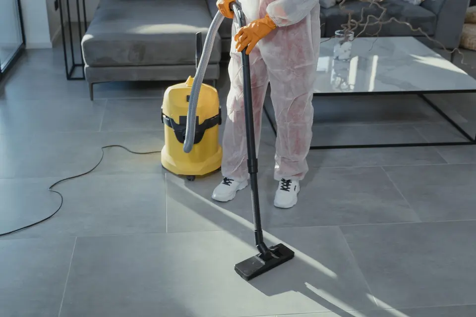 Post-construction deep clean with a wet/dry vacuum on a tiled floor